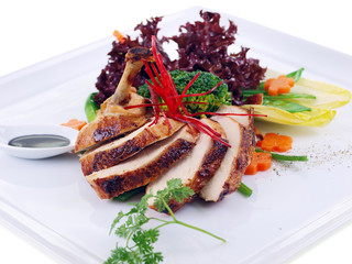 grilled guinea fowl with salad isolated on white background