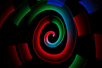 Abstract multicolored glowing in spiral pattern on black