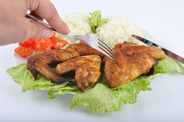 Chicken wings with rice, vegetable and cutlery