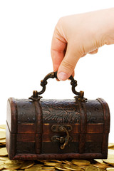 Wooden casket full of coins isolated on white