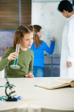 School children and teacher in science class