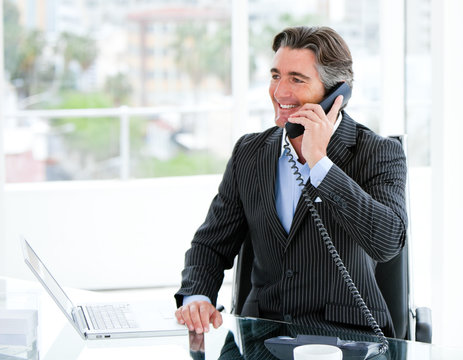 Smiling Mature Businessman Talking On Phone