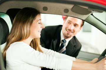 Woman buying car from salesperson