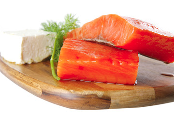 pink salmon on wooden plate with cheese