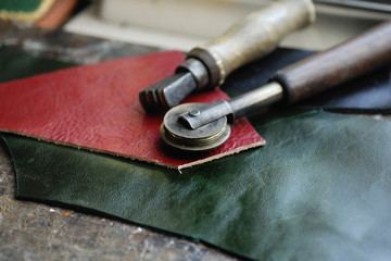 Piece of leather and some tools - obrazy, fototapety, plakaty