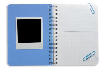 Spiral notepad and black instant photo isolated on a white