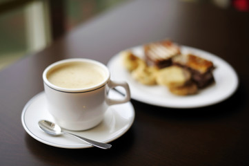 Coffee cup and a plate with cookies