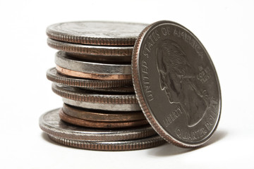 Leaning quarter and a stack of coins