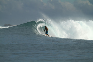 Surfer on wave, Indonesia
