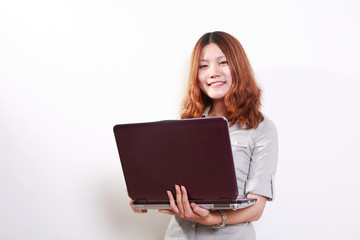 Naklejka premium Laughing woman using a laptop against a white background .
