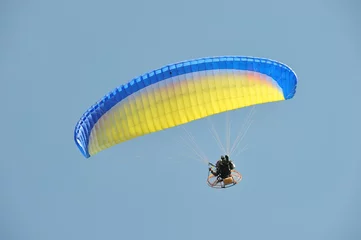 Papier peint photo Sports aériens paraglider flying in the sky  © stefanov764