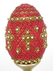 Easter egg decorated with red and golden glass beads