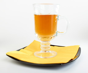 Сup of tea on black plate