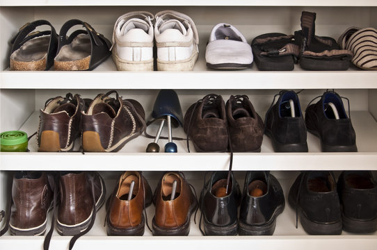 Placard &agrave; chaussures, chaussures hommes rang&eacute;es sur des &eacute;tag&egrave;res dans un meuble