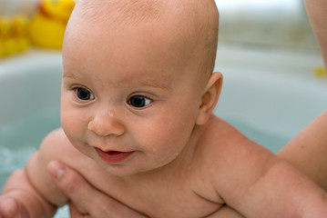 white baby taking a bath, close-up