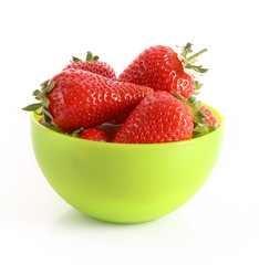 Few strawberries in green cup isolated on white