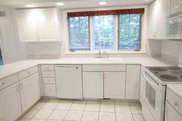 Fototapeta na wymiar Wide Angle View of Well Lit Beautiful White Kitchen