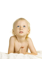 Cute young boy looking up praying. Isolated over white