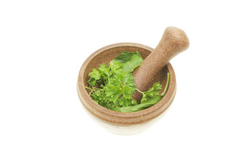 Fresh herbs in a pestle and mortar
