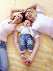 Happy family plays in the bed