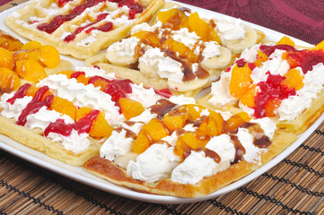 Homemade wafle with mandarin and caramel icing