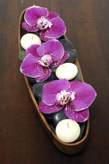 Aromatic candle and orchid ,stones  in scented water