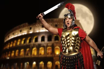 Wall murals Knights Roman legionary soldier in front of coliseum at night time