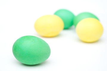 five yellow and green Easter eggs isolated on white