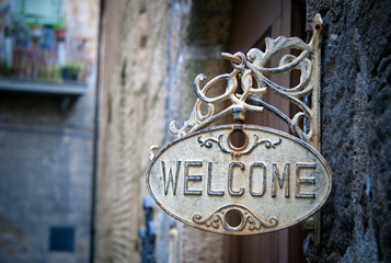 Welcome sign on log home