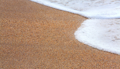 Sea surf foam on coastline sand