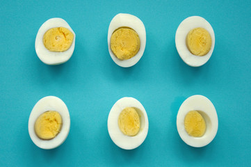 six sliced eggs on blue