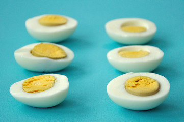six sliced eggs on blue