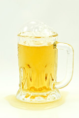 light beer glass with foam on a top