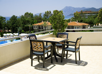 Plakat table and chairs in tourist resort in a hot canicular day