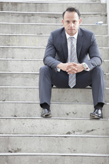 Businessman sitting on a staircase