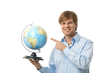Fototapeta premium Young man pointing to globe
