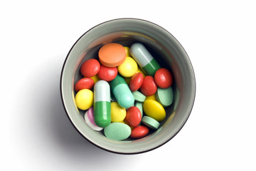 Bowl of multicolored tablets and capsules