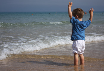 2-year-old child playing on the beach