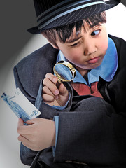 boy in a suit holding euro banknote under a magnifying glass