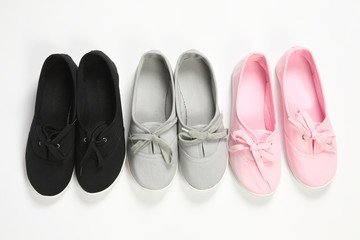 grey ,pink and black women shoes with white background