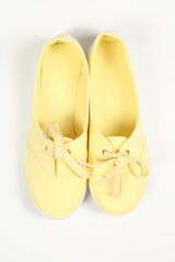 a pair of yellow women shoes and white background