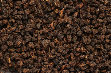 Granular black tea on a white background