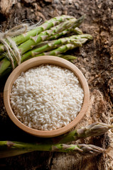 bowl with rice and raw asparagus