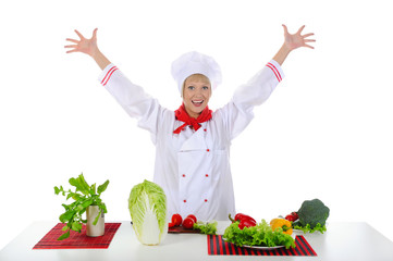 Positive handsome chef prepares vegetables