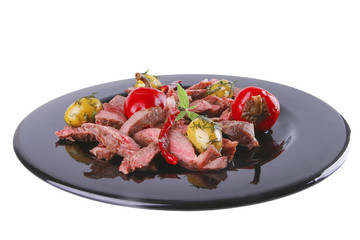 roast meat slices on black dish