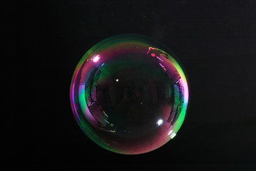 Soap bubbles on black background .