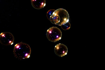 Soap bubbles on black background .