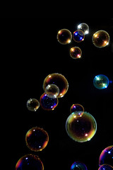 Naklejka premium Soap bubbles on black background .
