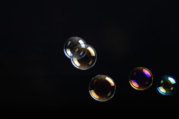 Soap bubbles on black background .