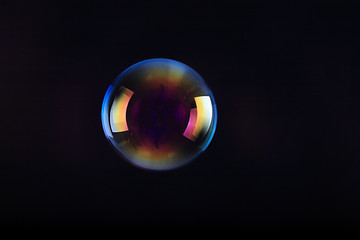 Soap bubbles on black background .